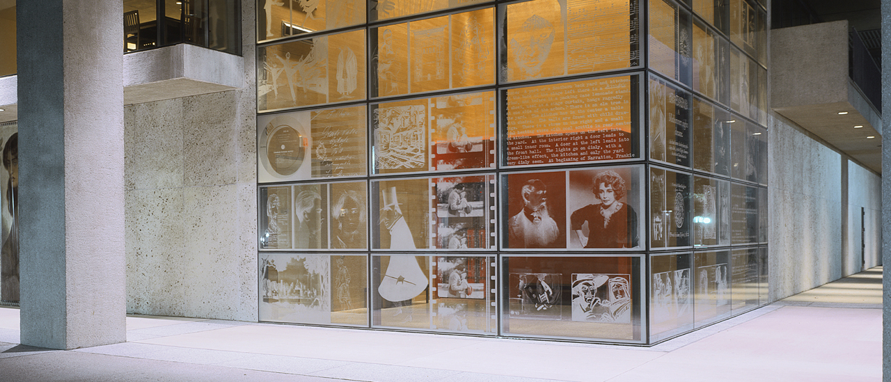 The exterior of the Harry Ransom Center focusing on the etched art on the windows.