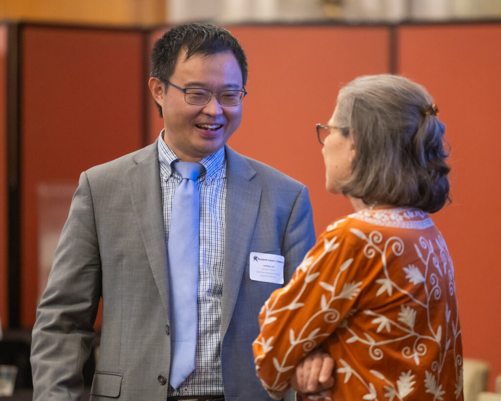 Male faculty member speaking to provost Sharon Wood